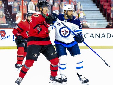 Ottawa Senators defenceman Jacob Bernard-Docker (48) checks Winnipeg Jets left wing Mathieu Perreault (85).