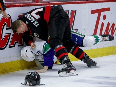 Ottawa Senators left wing Brady Tkachuk (7) fights with Vancouver Canucks centre Zack MacEwen.