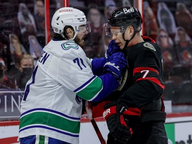Ottawa Senators left wing Brady Tkachuk (7) battles with Vancouver Canucks centre Zack MacEwen.