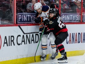 Ottawa Senators centre Clark Bishop (62) checks Edmonton Oilers centre Leon Draisaitl.