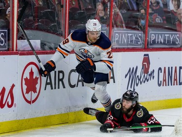 Ottawa Senators centre Clark Bishop (62) checks Edmonton Oilers centre Leon Draisaitl.