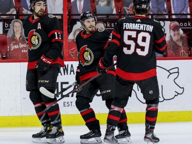 Ottawa Senators defenceman Victor Mete (98) celebrates his goal against the Vancouver Canucks with teammates left wing Nick Paul (13) and left wing Alex Formenton.