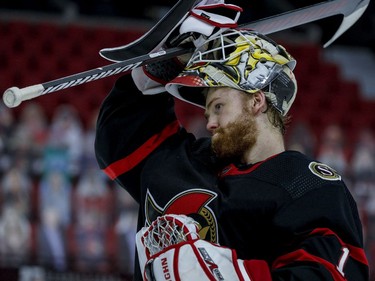 Ottawa Senators goaltender Marcus Hogberg (1) lifts his mask during a second-period break against the Vancouver Canucks at the Canadian Tire Centre.