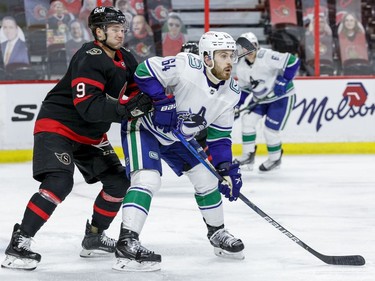Ottawa Senators centre Josh Norris (9) battles with Vancouver Canucks centre Tyler Motte.