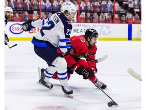 Ottawa Senators left wing Nick Paul (13) battles for a loose puck with Winnipeg Jets centre Mason Appleton, April 14, 2021.
