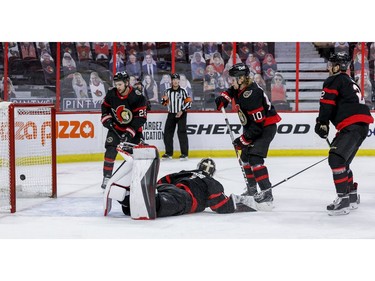 Ottawa Senators defenceman Erik Brannstrom (26), goaltender Marcus Hogberg (1), left wing Ryan Dzingel (10) and defenceman Artem Zub (2) can only watch as the Vancouver Canucks score during the second period.