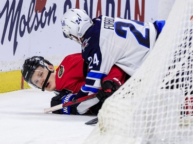Ottawa Senators left wing Brady Tkachuk (7) battles with Winnipeg Jets defenceman Derek Forbort.