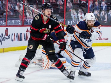 Ottawa Senators left wing Brady Tkachuk (7) takes a high stick to then face from Edmonton Oilers defenceman Adam Larsson (6) during the first period.