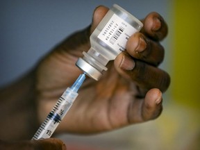 A syringe is loaded with the Pfizer vaccine at a vaccination clinic.