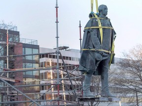 In this Jan. 31, 2018 file photo, contractors remove the statue of Edward Cornwallis in a city park in Halifax. The controversial Halifax figure offered a cash bounty to anyone who killed a Mi'kmaw person.