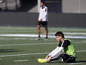 Drew Beckie stretches after Ottawa Fury FC practice at TD Place in 2015.