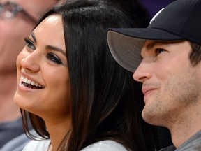 Actors Ashton Kutcher (right) and Mila Kunis sit courtside at the Los Angeles Lakers NBA match up against the Phoenix Suns Los Angeles February 12, 2013.