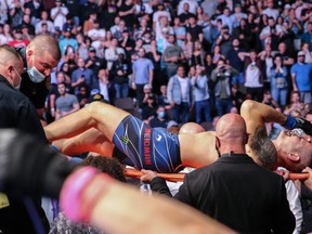 Chris Weidman leaves the fight on a stretcher after breaking his leg on a kick attempt to Uriah Hall during UFC 261 at VyStar Veterans Memorial Arena in Jacksonville, Fla., April 24, 2021.