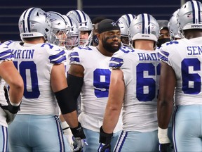 Everson Griffen, centre, of the Dallas Cowboys huddles with teammates prior to the start of a game against the Arizona Cardinals at AT&T Stadium on Oct. 19, 2020, in Arlington, Texas.