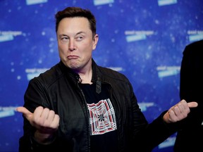 SpaceX owner and Tesla CEO Elon Musk grimaces after arriving on the red carpet for the Axel Springer award, in Berlin on Dec. 1, 2020.