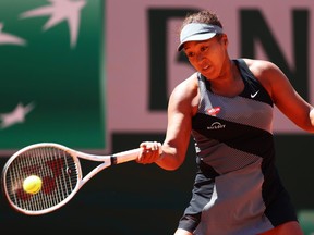 Naomi Osaka of Japan plays a forehand in her First Round match against Patricia Maria Tig of Romania during Day 1 of the 2021 French Open at Roland Garros on May 30, 2021 in Paris, France.