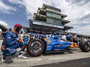 Chip Ganassi Racing driver Scott Dixon (9) poses with the pole position trophy for the 2021 Indianapolis 500 at the Indianapolis Motor Speedway.