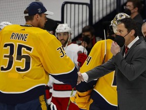 Carolina Hurricanes head coach Rod Brind'Amour (right) shakes hands with Nashville Predators goaltender Pekka Rinne after the Predators were eliminated from the NHL playoffs on May 27, 2021 in Nashville.