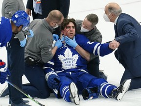 Toronto Maple Leafs medical staff attend to forward John Tavares after a collision with Montreal Canadiens forward Corey Perry (not pictured) during the first period of Game 1 of the first round of the 2021 Stanley Cup Playoffs at Scotiabank Arena in Toronto, May 20, 2021.