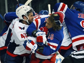 Tom Wilson #43 of the Washington Capitals takes a roughing penalty during the second period against Artemi Panarin of the New York Rangers at Madison Square Garden.