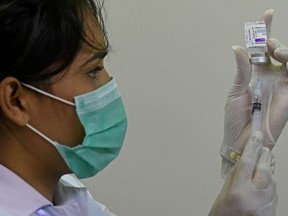 A health worker prepares a dose of the Covishield AstraZeneca-Oxford's Covid-19 coronavirus vaccine at a vaccination centre in Karachi on May 12, 2021.