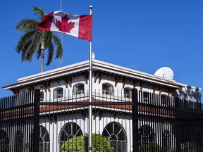 FILE: A man walks beside Canada's embassy in Havana, Cuba. THE CANADIAN PRESS/AP-Desmond Boylan