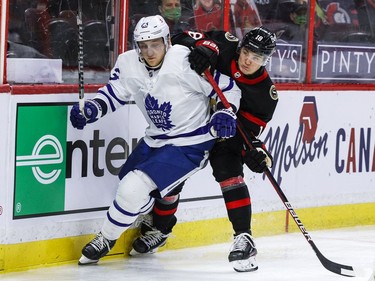 Ottawa Senators left wing Tim Stuetzle (18) and Toronto Maple Leafs defenceman Travis Dermott get tangled up during the third period.