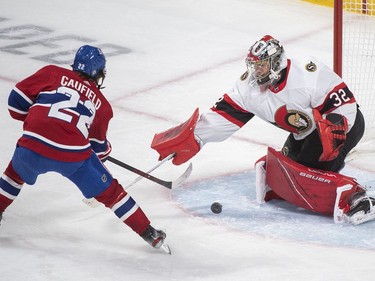 Montreal Canadiens' Cole Caufield moves in on Ottawa Senators goaltender Filip Gustavsson during second period NHL hockey action in Montreal, Saturday, May 1, 2021.