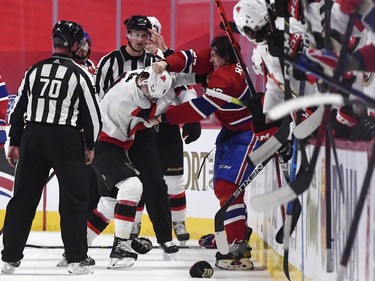 Ottawa Senators forward Josh Norris (9) fights with Montreal Canadiens defenceman Alexander Romanov (27) during the second period at the Bell Centre.