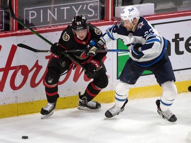 Ottawa Senators centre Shane Pinto (57) battles for the puck with Winnipeg Jets centre Trevor Lewis (23) in the third period at the Canadian Tire Centre.