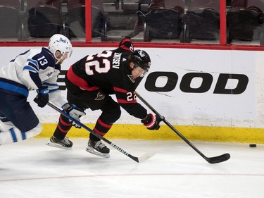 Winnipeg Jets left wing Pierre-Luc Dubois (13) chases  Ottawa Senators defenceman Nikita Zaitsev (22) in the third period at the Canadian Tire Centre.