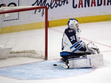 Winnipeg Jets goalie Laurent Brossoit (30) reacts to a goal scored in the third period by Ottawa Senators defenceman Nikita Zaitsev (22-not pictured) at the Canadian Tire Centre.