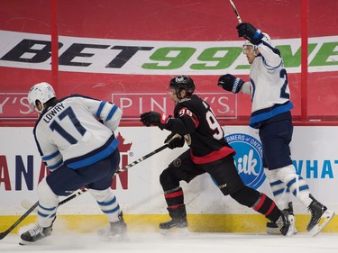 Winnipeg Jets centre Mason Appleton (22) recovers from a check by Ottawa Senators defenceman Victor Mete (98) in the first period at the Canadian Tire Centre.