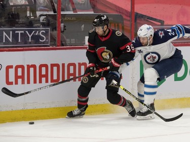 Ottawa Senators centre Colin White (36) battles with Winnipeg Jets defenceman Derek Forbort (24) in the second period at the Canadian Tire Centre.