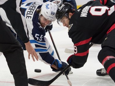 Winnipeg Jets centre Mark Scheifele (55) faces off against  Ottawa Senators centre Josh Norris (9) in the second period at the Canadian Tire Centre on Monday.