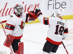 Ottawa Senators goaltender Filip Gustafsson (32) and left wing Tim Stuetzle (18) celebrate their win against the Winnipeg Jets at Bell MTS Place on May 9, 2021 .