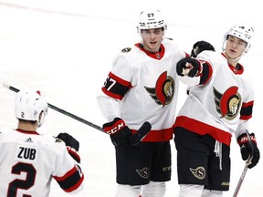 Ottawa Senators left wing Tim Stuetzle (18) celebrates with Ottawa defenceman Artem Zub (2) and centre Shane Pinto after scoring one of his three goals against the Winnipeg Jets at Bell MTS Place on Saturday.
