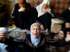 The mother of Palestinian Rasheed Abu Arra, who was killed during clashes with Israeli forces, mourns her son alongside other women, during his funeral in the town of Aqqaba near Tubas, in the Israeli-occupied West Bank, May 12, 2021.