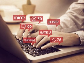cyber bullying concept. people using notebook computer laptop for social media interactions with notification icons of hate speech and mean comment in social network