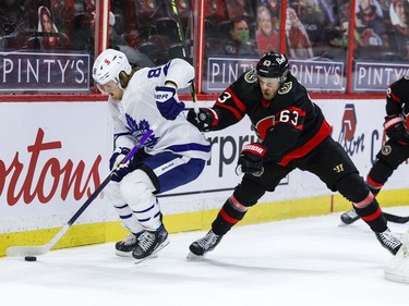 Toronto Maple Leaf William Nylander (88) keeps the puck away from Ottawa Senators right wing Evgenii Dadonov.