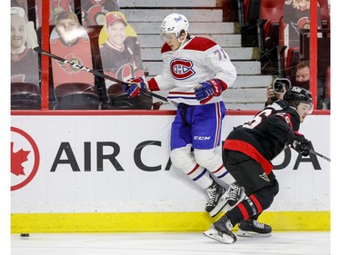 Ottawa Senators defenceman Erik Brannstrom (26) checks Montreal Canadiens centre Jake Evans (71) during the second period.