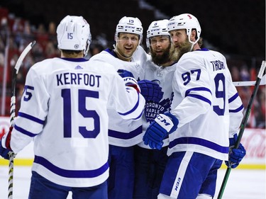 Toronto Maple Leafs Alexander Kerfoot (15), Jason Spezza (19), Jake Muzzin (8) and Joe Thornton (97) celebrate Muzzin's goal against the Ottawa Senators during the second period.