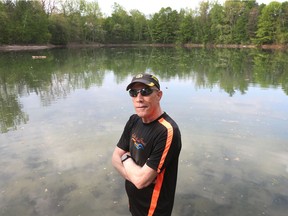 Tim Scapillato poses for a photo at The Pond in Rockcliffe Park in Ottawa Tuesday. Tim is an open water swimmer and was part of an ad hoc organization that came up with a compromise with the NCC to allow open water swimming again at Meech Lake and Lac Leamy.