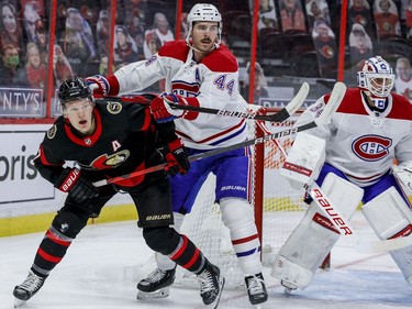 Ottawa Senators left wing Brady Tkachuk (7) battles with Montreal Canadiens defenceman Joel Edmundson (44) beside goaltender Jake Allen (34) during the first period.