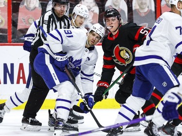 Ottawa Senators centre Shane Pinto (57) and Toronto Maple Leafs centre John Tavares (91) follow the puck after a faceoff.