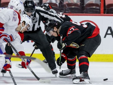 Ottawa Senators centre Shane Pinto (57) wins the draw cleanly against Montreal Canadiens centre Nick Suzuki (14).