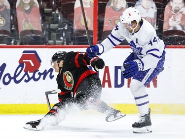 Ottawa Senators left wing Tim Stuetzle (18) and Toronto Maple Leafs defenceman Morgan Rielly battle during the first period at the Canadian Tire Centre on Wednesday, May 12, 2021.