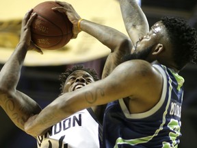 File photo/ London Lightning's Eric Kibi works in on Niagara River Lion's Sauel Mudrow and draws a foul during their game at Budweiser Gardens in London, Ont. on Wednesday April 6, 2016.