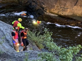 Ottawa- Police and firefighters converged on Hog's Back Bridge over the Rideau River at Hog's Back Falls on the evening of Saturday May 15,2021. Members of a water rescue team swam in to the Rideau River and searched just downstream from the roaring falls.