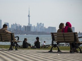 People enjoy the warm weather in the Humber Bay Shores area in Toronto, Ont. on Saturday, April 10, 2021.